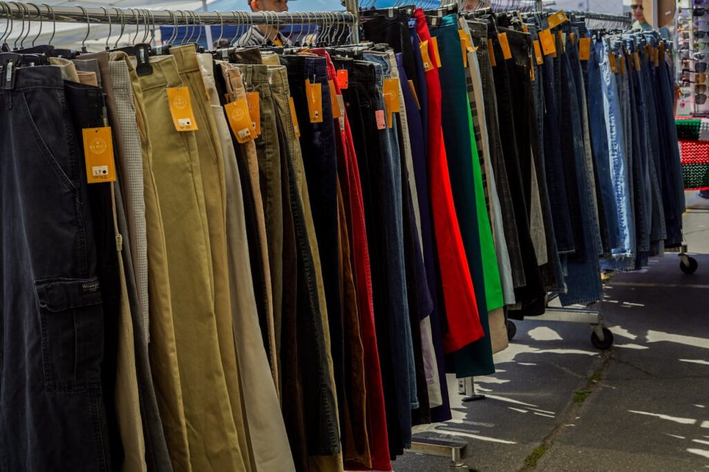 A rack of clothes with many different colors